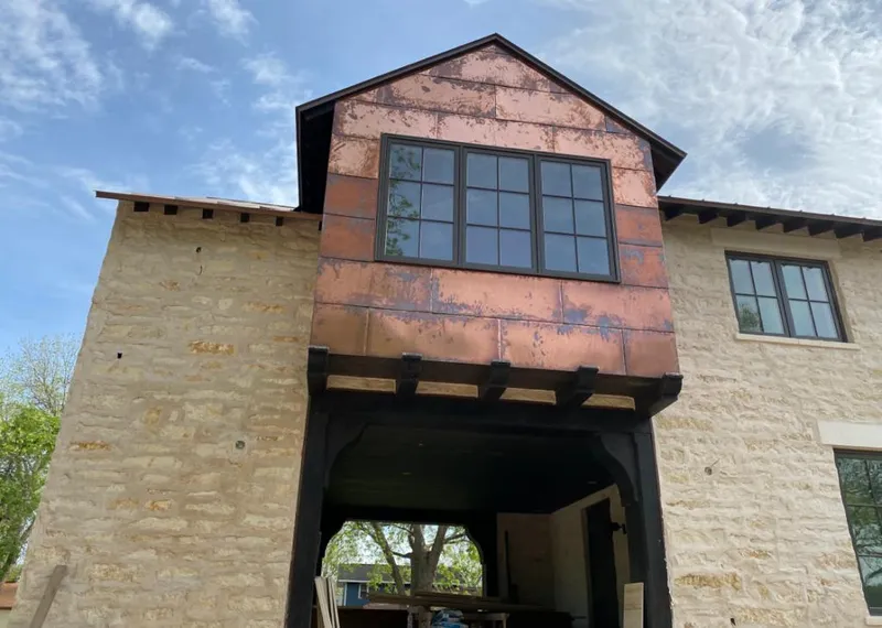 Copper metal panel facade on a stone building for Skylight Installation in Avondale